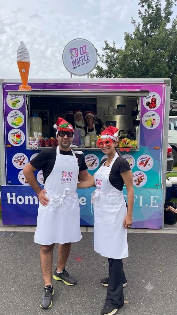 OzWaffle founders Mahyar and Mahsa in Christmas hats at the OzWaffle trailer